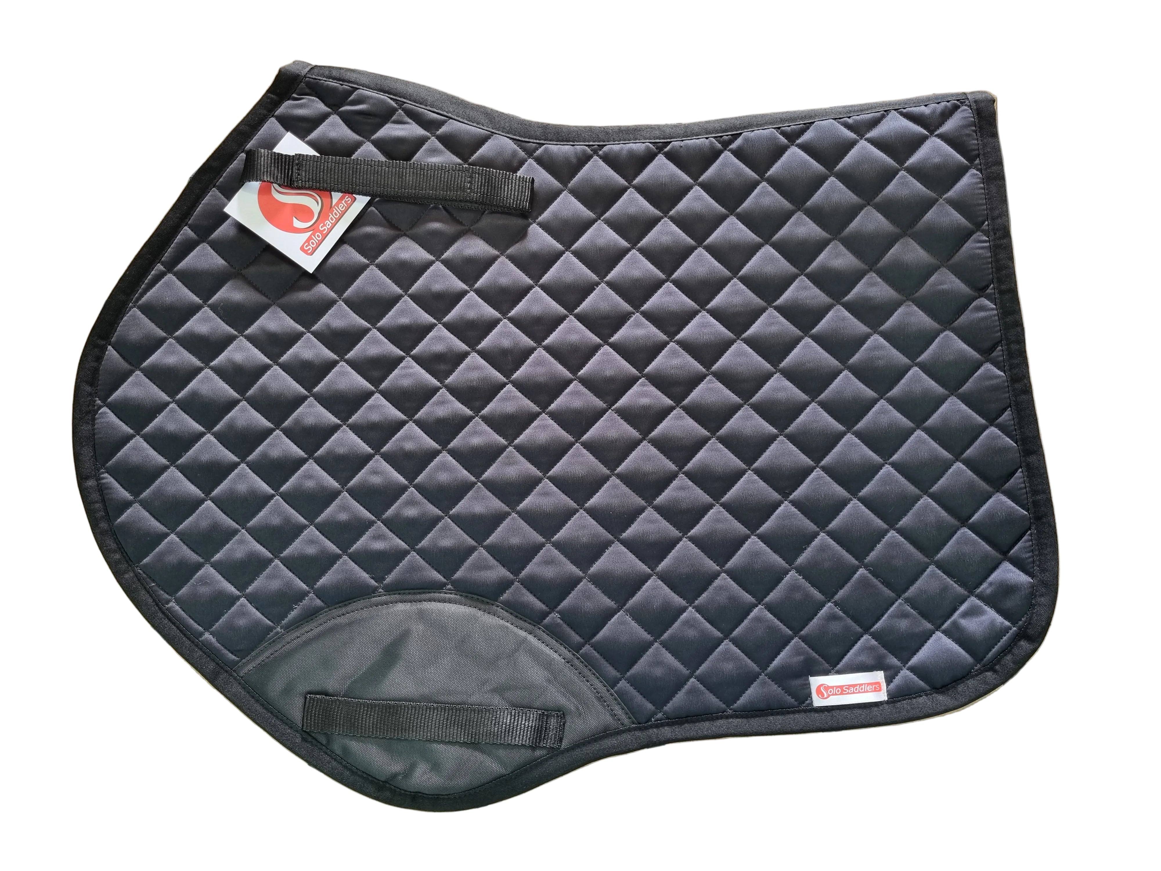 A dark gray quilted equestrian saddle pad with black trim and straps, laid flat on a tan tiled floor. A small red and white brand tag is visible on the lower right corner.